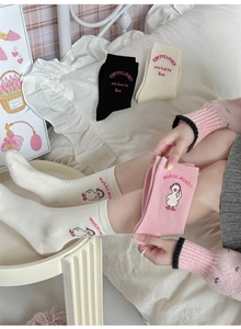 Close-up of pink headphones duck embroidery on soft cotton crew socks in pastel colors