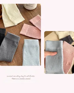 Close-up of ribbed cotton socks featuring embossed bear patterns in multiple pastel colors