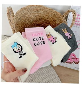 Close-up of cute cartoon cat and bunny embroidery on soft cotton mid-calf socks