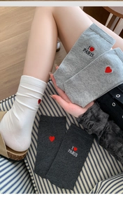 Detail of red heart embroidery and PARIS lettering on grey ribbed knit cotton socks