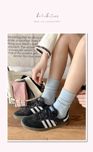 Detail of ribbed mid-calf socks with cute 3D bear embroidery in soft pastel colors