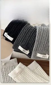 Detail of cable knit crew socks with egg label and textured cotton ribbed fabric