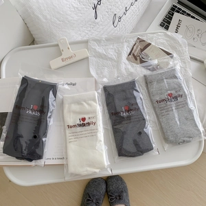 Set of 4 pairs of cotton crew socks in black, white, and grey with heart embroidery