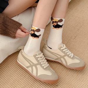Women's cute cartoon dachshund crew socks in white paired with beige retro sneakers