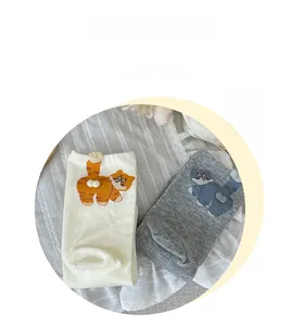 Detail of cute cat socks with 3D pom-pom tails on premium combed cotton fabric