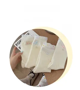 Detailansicht weißer Socken mit Spitzenbesatz und süßen pastellfarbenen Schleifen
