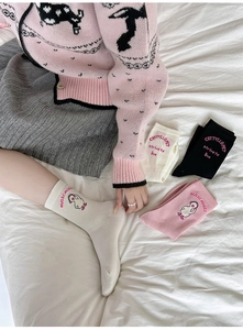 Detailed view of pink cotton crew socks featuring cute cartoon chick embroidery and letters