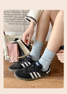 Close-up of ribbed cotton socks with cute bear embroidery in various pastel colors
