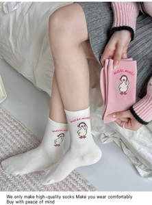 Close-up of cute cartoon duck embroidery and MUSIC text on pink cotton socks