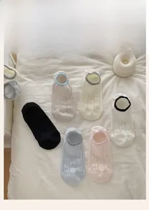 Detail of breathable low-cut socks with mesh patterns and delicate bow designs