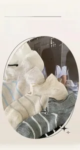 Detail of breathable striped ankle socks in neutral colors with knitted mesh texture
