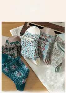 Close-up of vintage crew socks with 3D floral jacquard patterns and ribbed cuffs