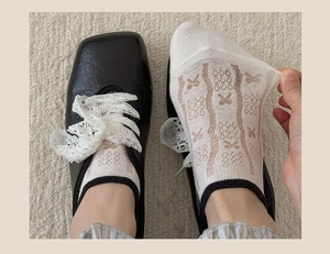 Detail of breathable white mesh socks with lace bow and black trim for women