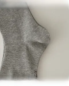 Detail of reinforced heel and flat toe seam on gray ribbed cotton crew socks