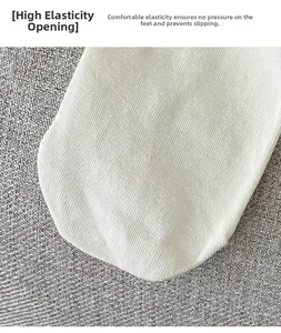 Macro shot of white ribbed cotton socks featuring a high-elastic comfort cuff detail