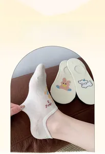 Detail of cream low-cut invisible socks featuring cute cartoon animal embroidery patterns