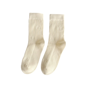 Minimalist cream knit mid-calf socks featuring embossed cartoon bear patterns and textures