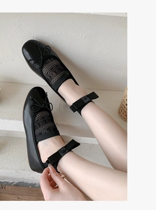 Detail of ballet style lace mesh flat with ribbon bow tie and delicate mesh pattern
