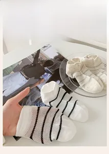 Detailed macro view of thin mesh stripes and ribbed cuffs on breathable summer socks