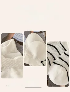 Macro detail of breathable mesh knitting and black stripes on white low cut cotton socks