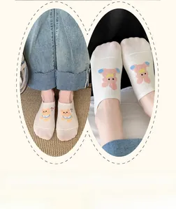 Detail of cute animal embroidery and non-slip silicone heel on white invisible socks