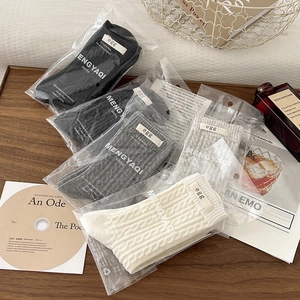 Knit mid-calf socks with twist patterns and egg label in various neutral colors