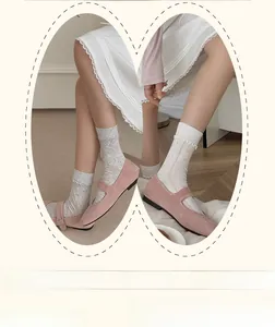 Detail of pink Mary Jane shoes with retro straps and white lace-trimmed cotton socks
