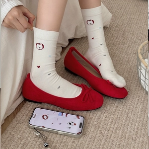 Cute white crew socks with apple and heart patterns paired with red ballet flats