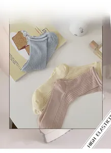Three pairs of pastel rib-knit crew socks in blue, beige, and pink with high elasticity