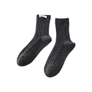 Dark grey cable knit crew socks with white egg label on ribbed cuffs for women