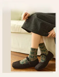 Close-up of vintage floral embossed knit socks worn with Mary Jane shoes and a long skirt