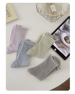 Set of pastel mesh crew socks in lilac, blue, green, and gray with ribbed texture