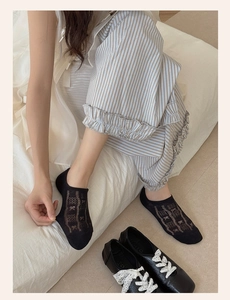 Detail of black low-cut boat socks with mesh hollow texture and feminine bow design