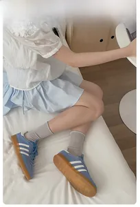 Blue retro sneakers with white stripes and translucent caramel rubber sole with socks