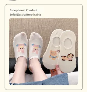 Close-up of white cotton no-show socks with cute cartoon animal patterns and high elasticity