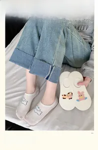 Detail of white low-cut invisible socks featuring cute cartoon animal embroidery
