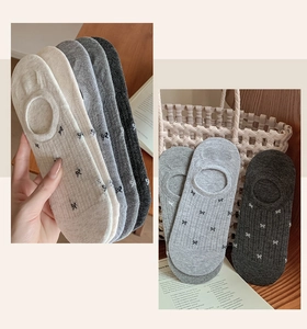 Detailed view of low-cut mesh invisible socks with bow prints and ribbed texture