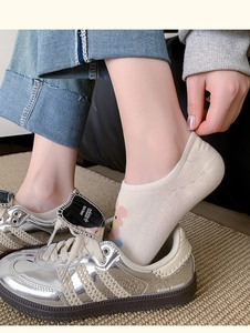 Close-up of white invisible socks with cute cartoon rabbit pattern and anti-slip silicone