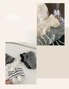 Detail view of cotton striped crew socks set in white, gray, and black classic colors