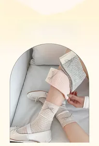Detail of breathable cotton mesh socks featuring elegant silver ribbon bows in soft colors