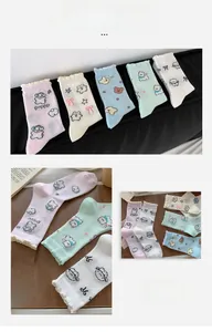 Detail of five pairs of pastel socks with cute puppy patterns and ruffled lace cuffs
