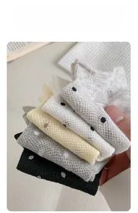 Detail of five colors of thin mesh cotton socks with knit dots and wavy rolled cuffs