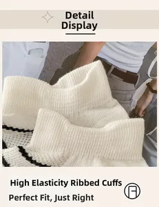 Detail of high-elastic ribbed cuff on white socks featuring slim black stripe trim