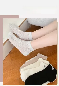 Detail of embroidered bear motif and ribbed texture on breathable cotton ankle socks
