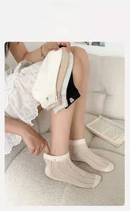 Detail of high-elasticity ribbed cuffs and cute bear embroidery on cotton socks