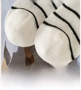 Close-up of breathable mesh fabric and seamless toe stitching on striped socks