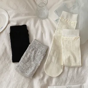 Three pairs of cotton crew socks with ruffle cuffs and vintage jacquard patterns