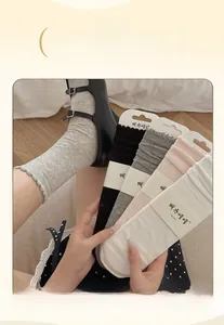 Detail of hollow bow-knot socks showing soft pastel colors and wide elastic lace cuffs