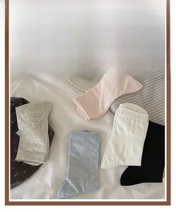 Flat lay of women's mesh crew socks in five colors including pink, grey, and black