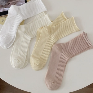 Four-pack of cream-colored mesh crew socks with ribbed texture and rolled cuffs